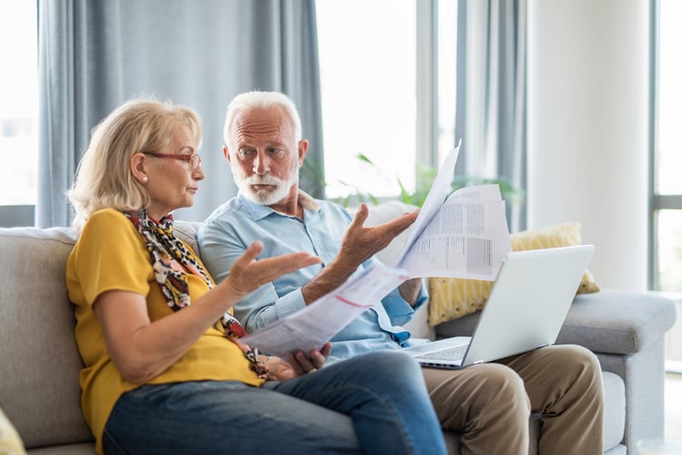 Elderly Couple reviewing Support at Home resources.