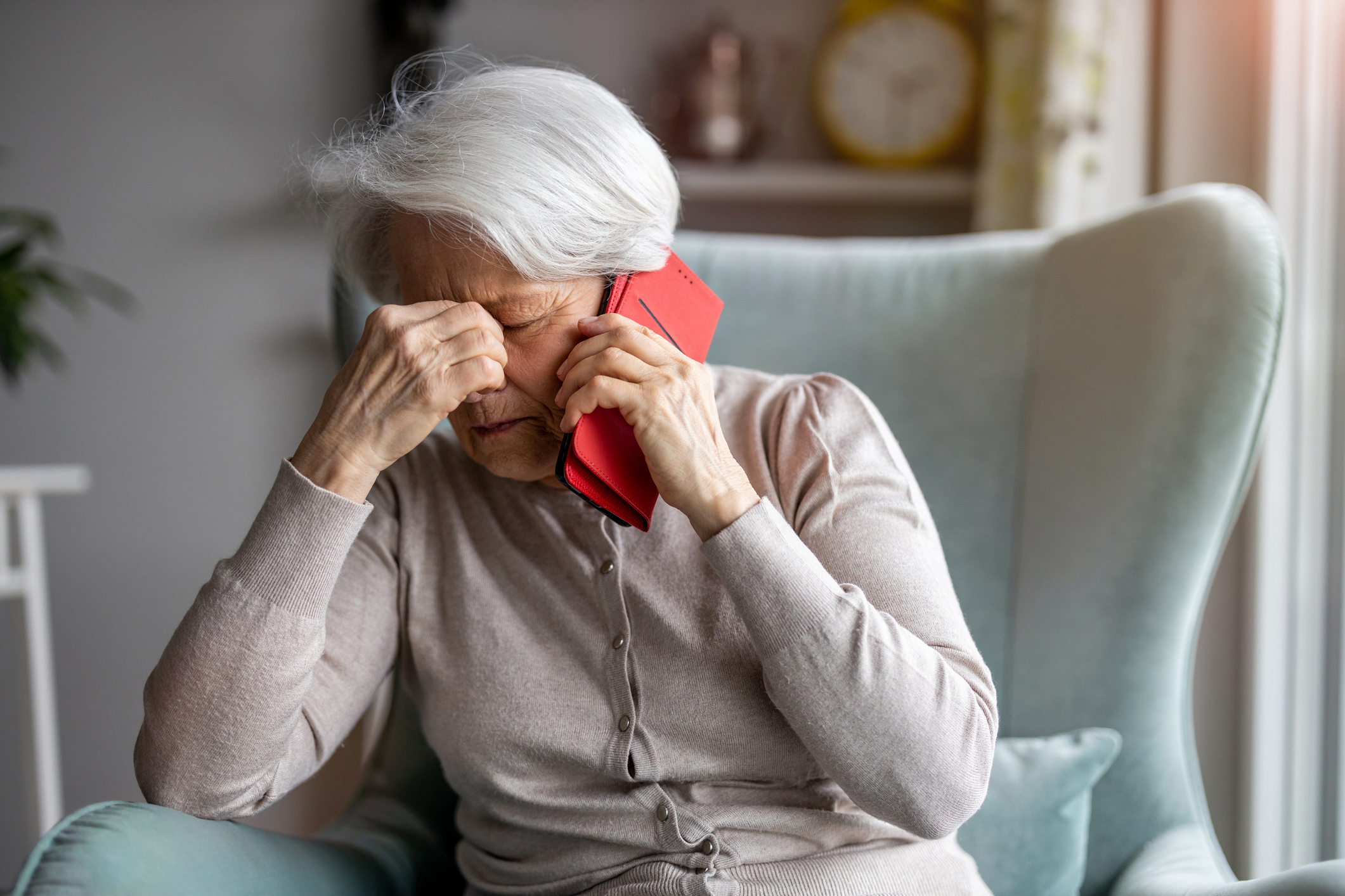 Senior frustrated on the phone with home care provider